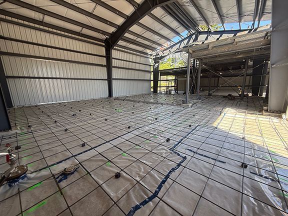 Detailed view of concrete floor preparation at commercial building site.