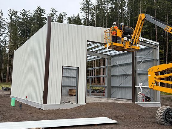 Front view of the building as metal wall panels are being completed.