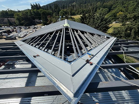 View of the metal structure supporting a standing seam roof in BC.