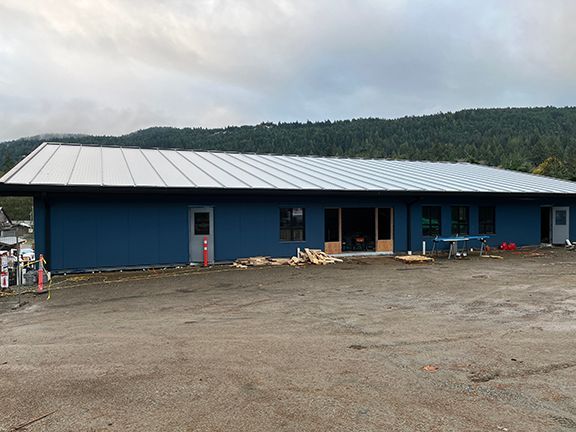 Top of the hill view of the metal building under construction on Salt Spring Island.