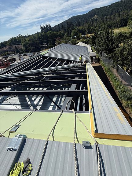 Insulated metal panels being installed on roof in Salt Spring Island, BC.