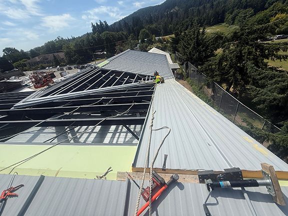 Metal standing seam roof structure at Windsor Plywood building project.