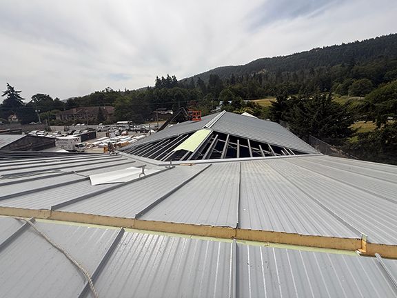 Top view of metal roof over mezzanine on Salt Spring Island building project.