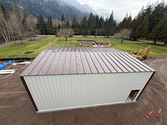 Building nears completion in site photo taken from above.