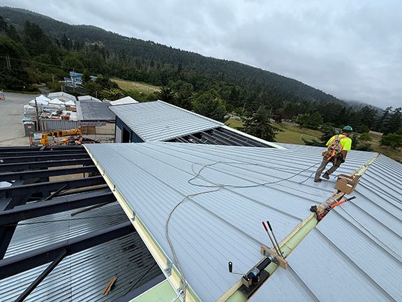 Pre-engineered metal building roof under construction in BC.