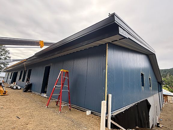 Side view of building showing the concrete retaining wall foundation below.