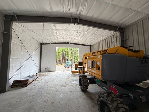Fire retardant sheeting added to interior of metal building project.