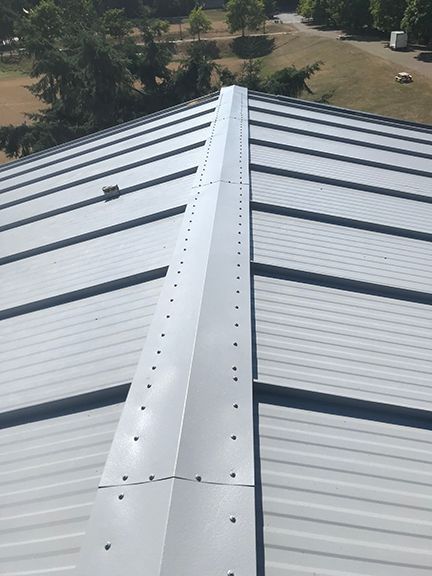 Finished metal stand seam roof at British Columbia building project in Ganges.