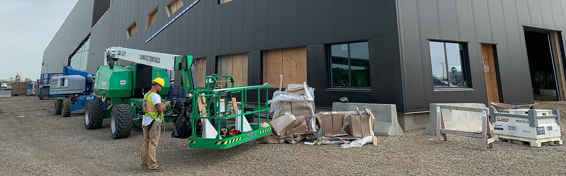 Skilled tradespeople add panels to a pre-engineered steel building in Brandon, Manitoba.