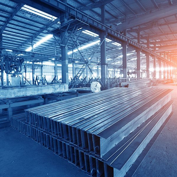 A warehouse filled with lots of steel beams stacked on top of each other.