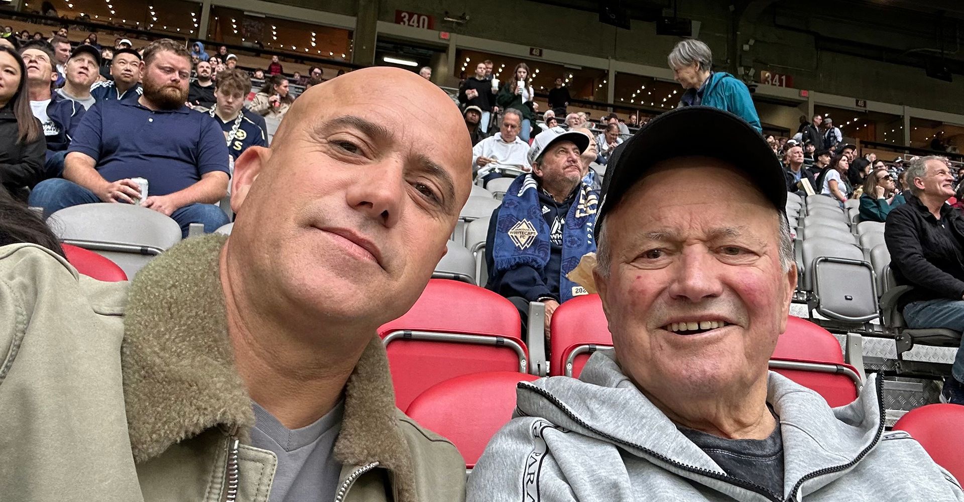 Photo of Frank and Benjamin Melo at a Vancouver Whitecaps MLS game in 2024.