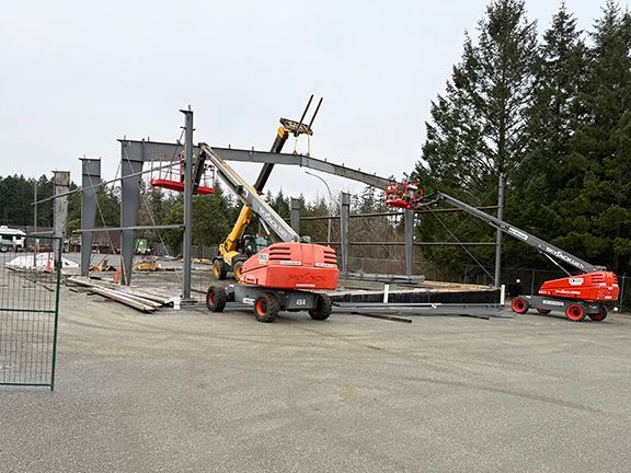 Steel crossbeams being added to industrial steel building framing.