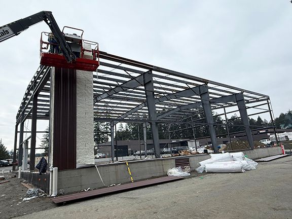 Insulation and steel panels being added to steel structural frame at construction project in B.C.