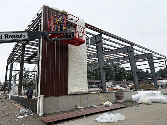 Insulated steel panels being added on a Nanaimo metal building project.