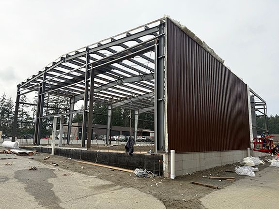 Brown steel panels being added by Double Black Construction.