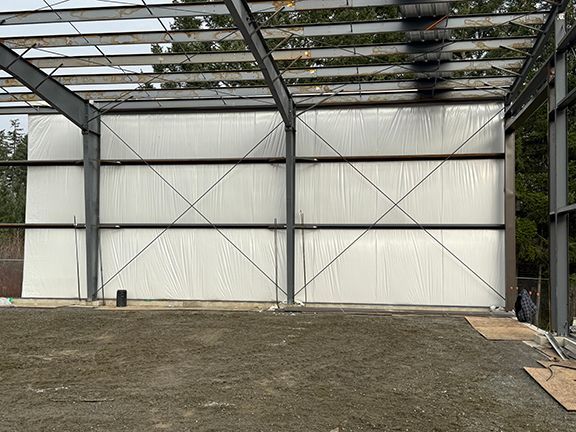 Interior view of protective wall lining on a metal building construction site.