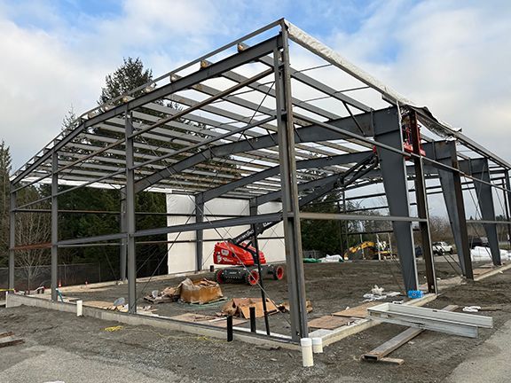 Look at steel building framing on a construction site in Nanaimo with some wall panels installed.