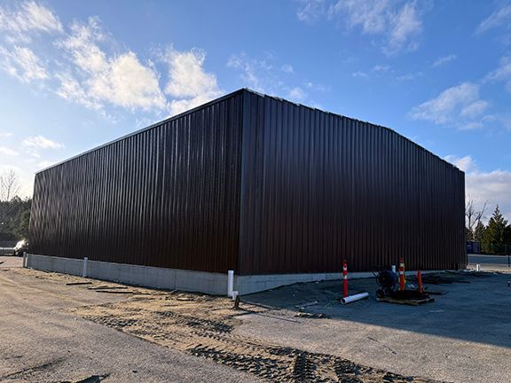 Exterior view of brown insulated metal panels (IMPs) at Vancouver Island building job site.