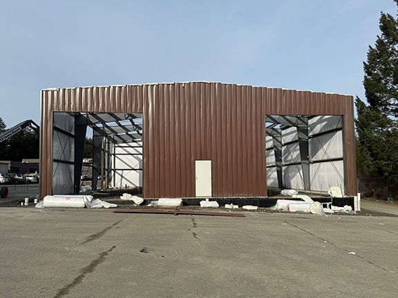 Front view of metal building workshop at project site on Vancouver Island.