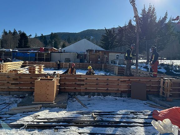 Construction worker team finishing  up wood forms in preparation for concrete pouring.