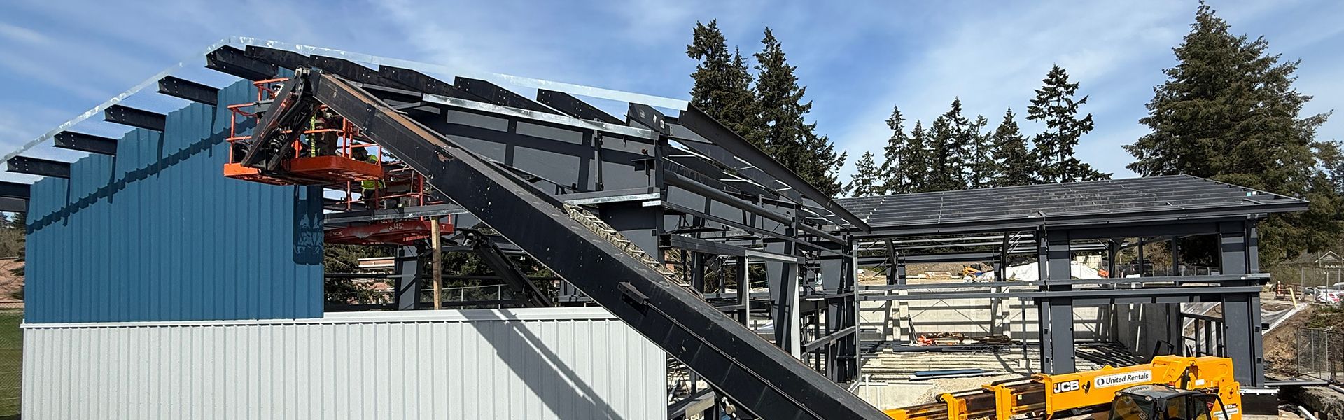 Skilled trades add metal wall siding to a metal building project on Salt Spring Island in B.C.