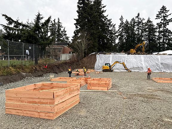 Wooden frames used to create concrete foundation supports being prepared.