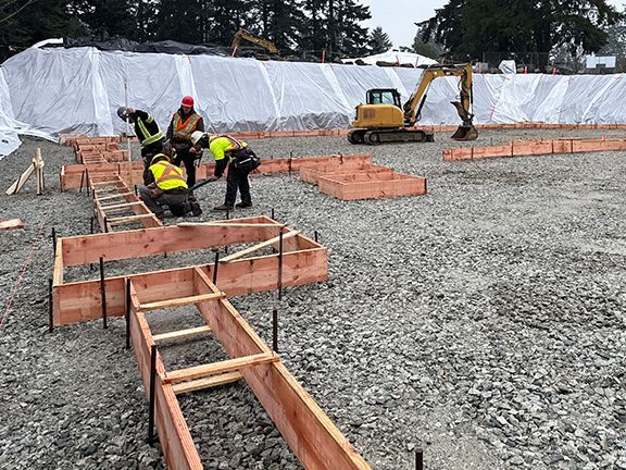 Concrete foundation frames being installed in advance of pouring.