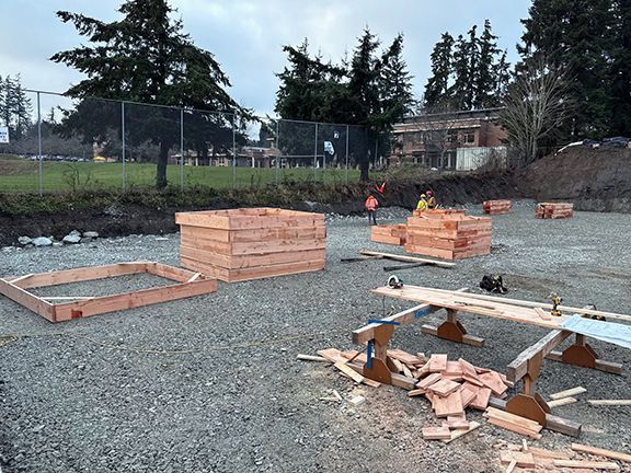 Double Black Construction site adding wooden boxes to support concrete foundation in British Columbia. 