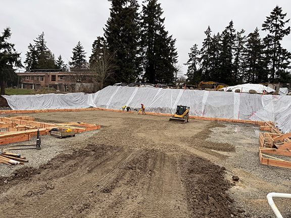 Site excavation continues in Salt Spring Island for Windsor Plywood metal building construction project.