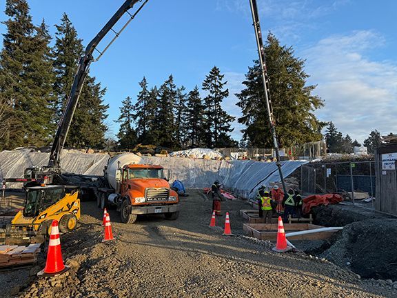 Concrete pill boxes get filled in advance of steel building framing.