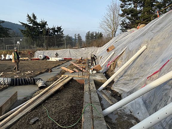 Wood planks are adding to excavation site for future concrete retaining wall forms.