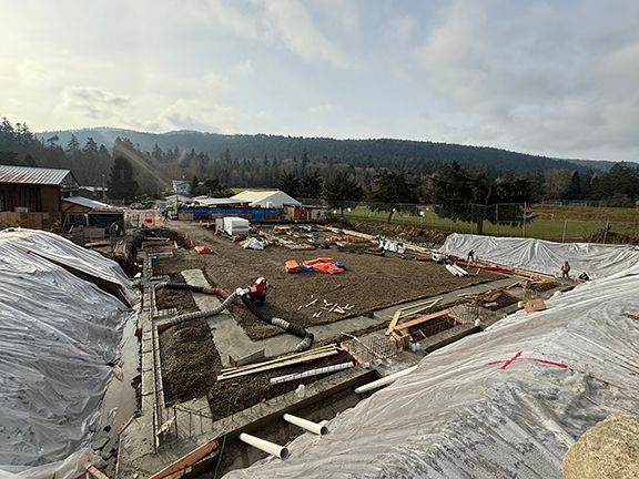 View of entire construction site as concrete being added to Salt Spring Island building project.