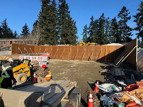 Look at jobsite with wood forms where concrete retaining wall be eventually be located.