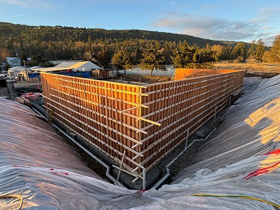 Spectacular view of wood forms atop concrete foundation prior to pouring of retaining wall.