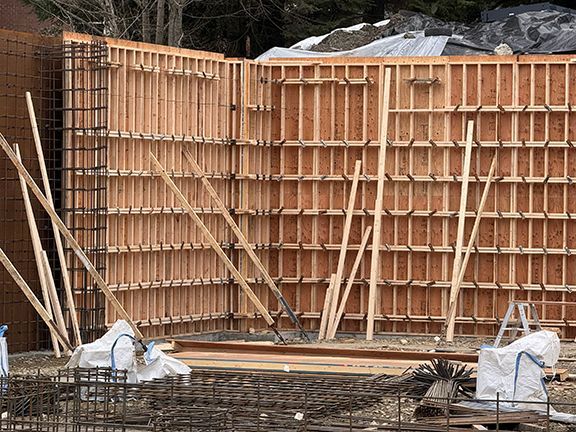 FormPly wood structure and rebar line future site of concrete retaining wall.