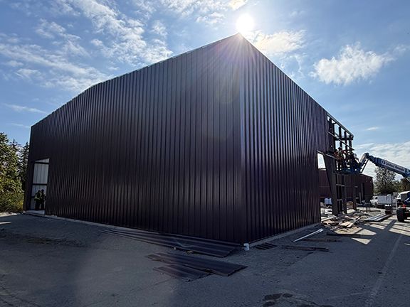 Two sides of metal building with completed exterior wall panels