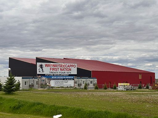 A large red building with a sign that says waywayseecappo first nation