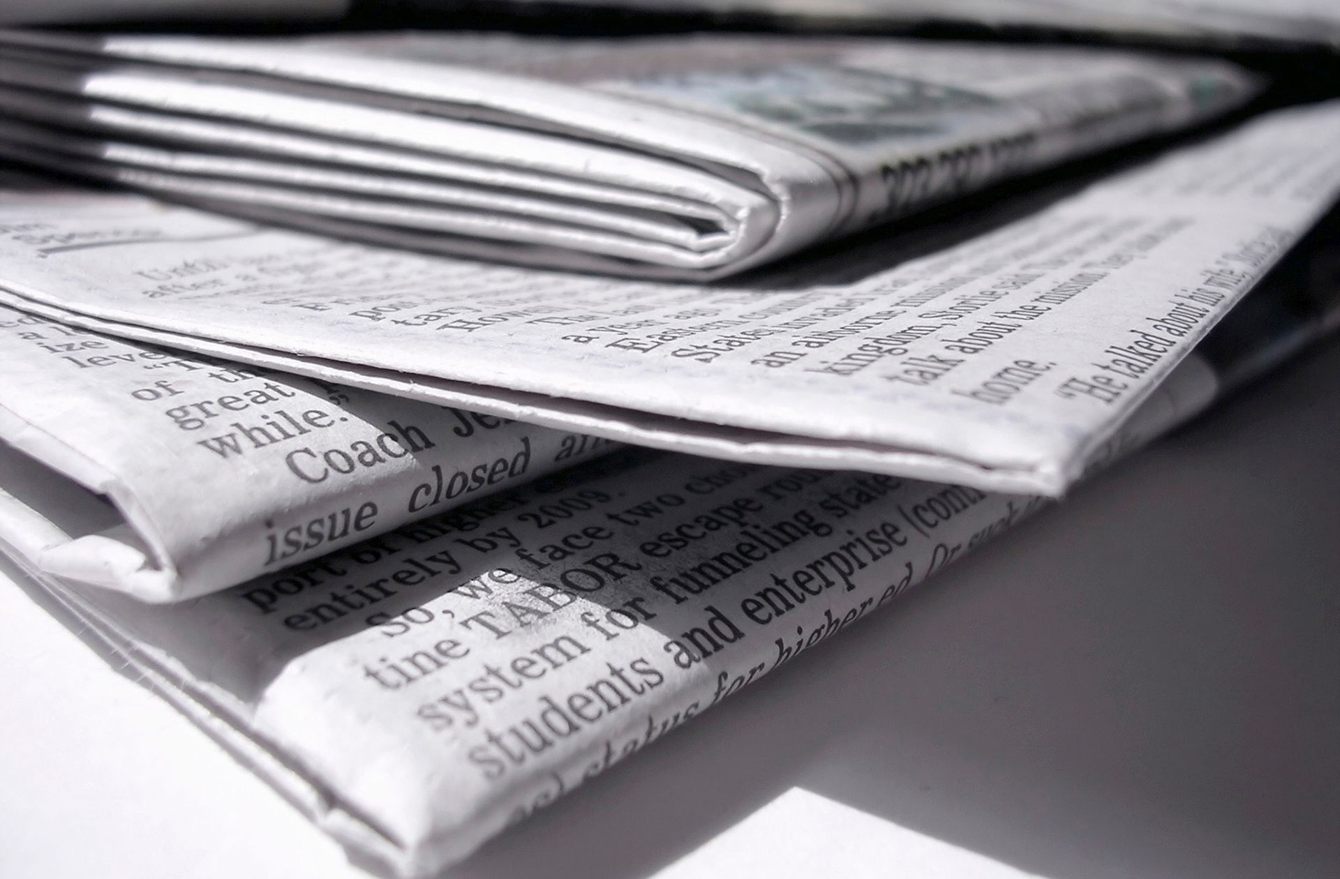 Newspapers showing press announcement