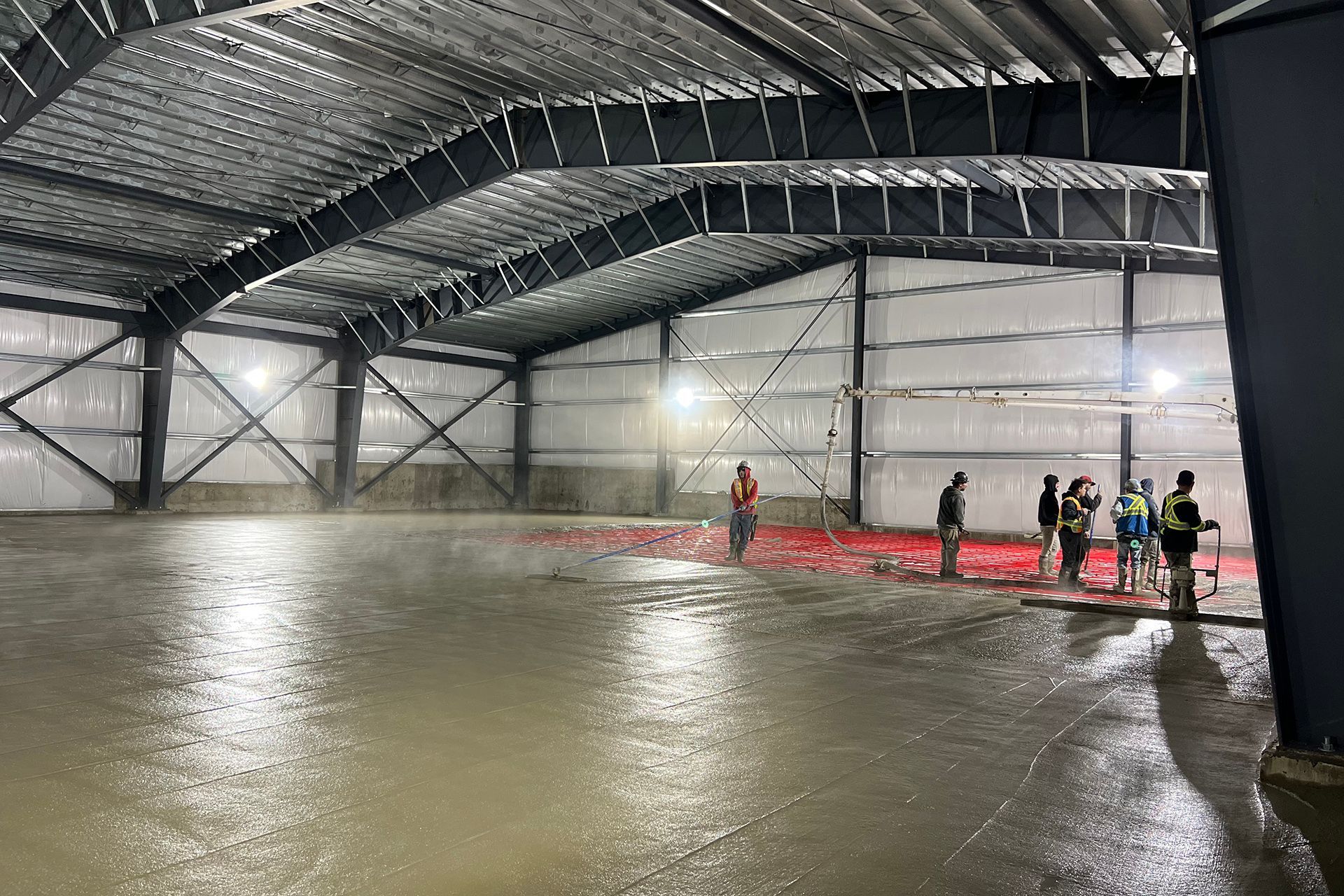 A group of people are standing in a large warehouse.