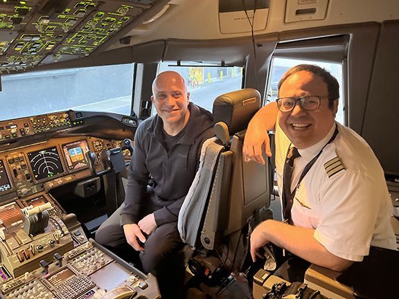 Frank Melo visits the cockpit on a flight back to Vancouver.