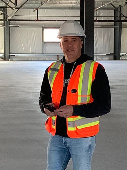 Frank Melo inspects the metal building project at FCMP in London, Ontario.