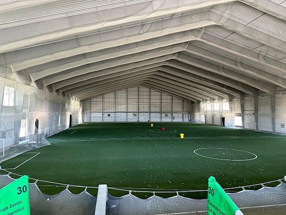 There is a soccer field inside of a building.