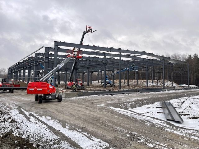 A large building is being built in the snow.