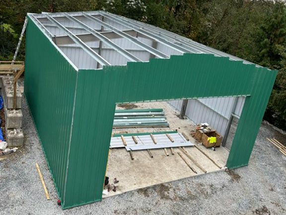 An aerial view of a building under construction with a green roof