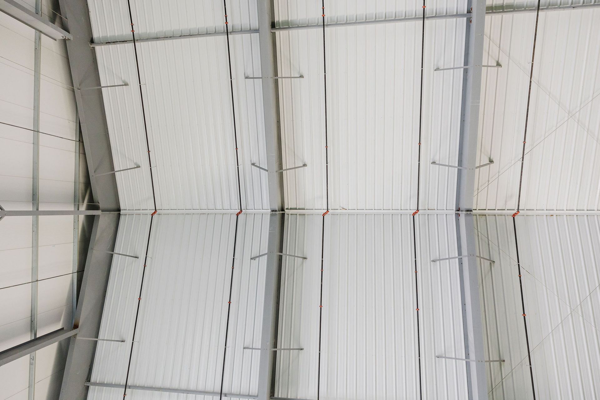 The ceiling of a building with a lot of lines on it.