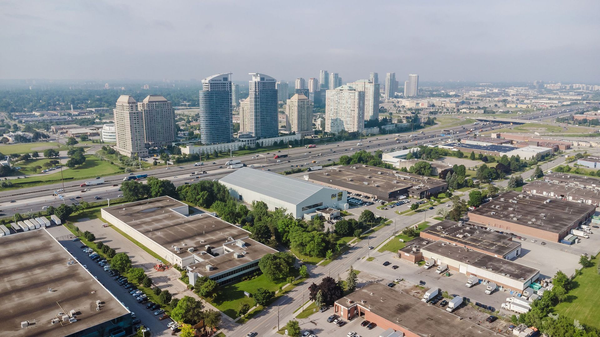 An aerial view of a city with a lot of buildings and a lot of traffic.