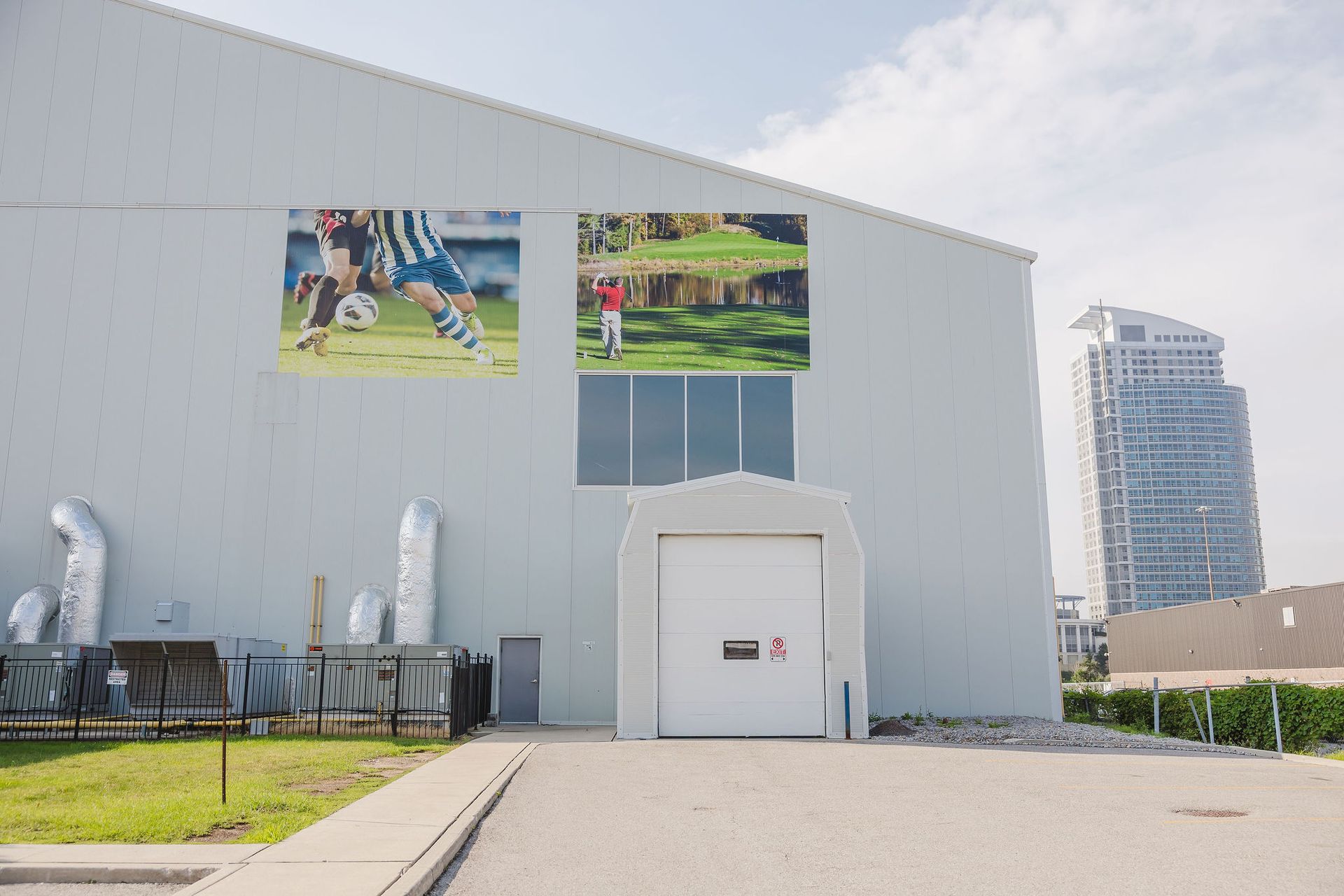 A large white building with a large picture of a soccer player on the side of it.