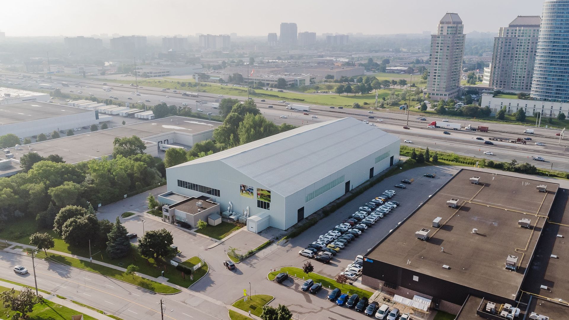 An aerial view of a large white building in the middle of a city.