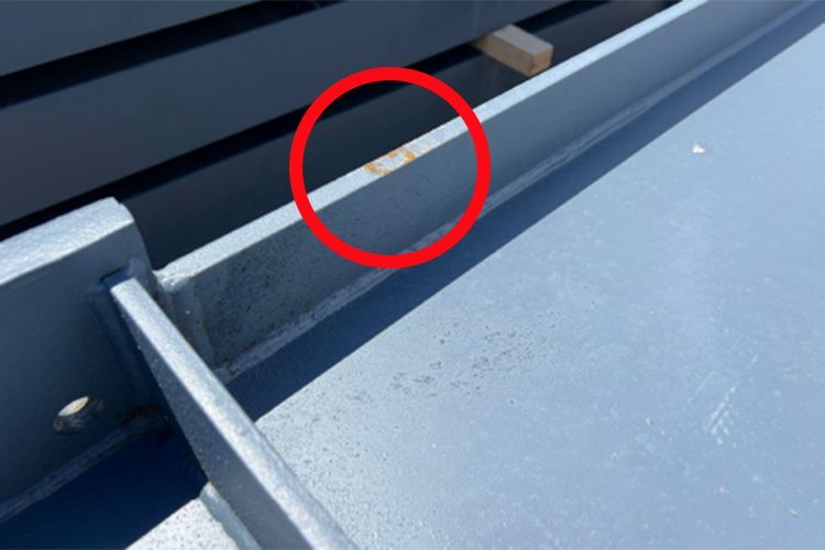 A close up of a metal beam with a red circle around it.