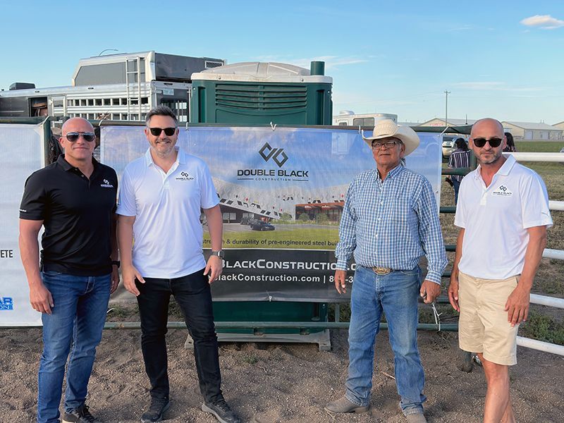 A group of men are standing next to each other in front of a sign.